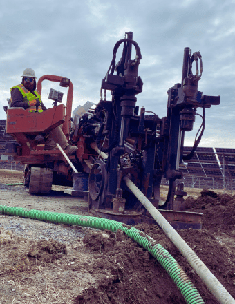 Horizontal drilling machine installing underground pipeline at construction site