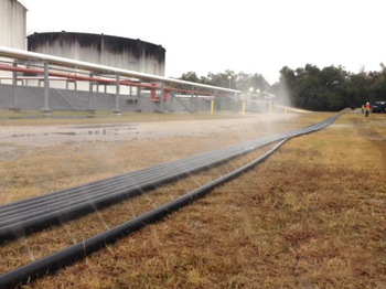 Water being pumped through horizontal remediation well to demonstrate uniform flow through well screen.